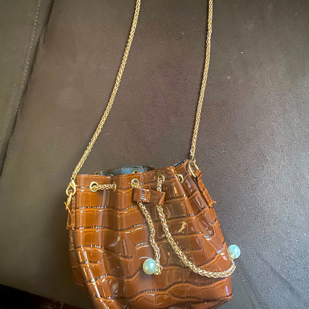 Brown vegan leather bag drawstring purse w/ gold chain strap.